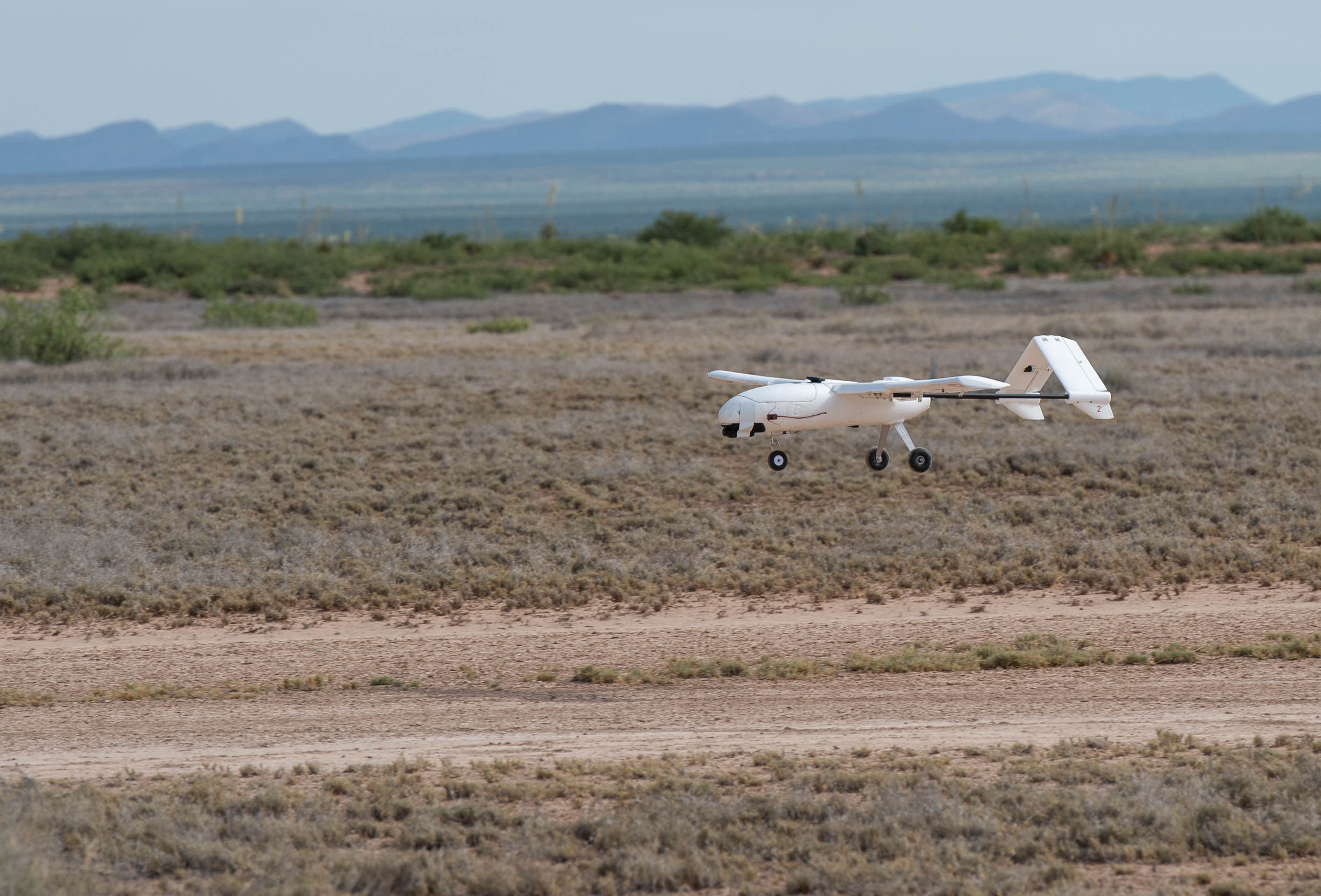 Drone lands on a dirt runway. 