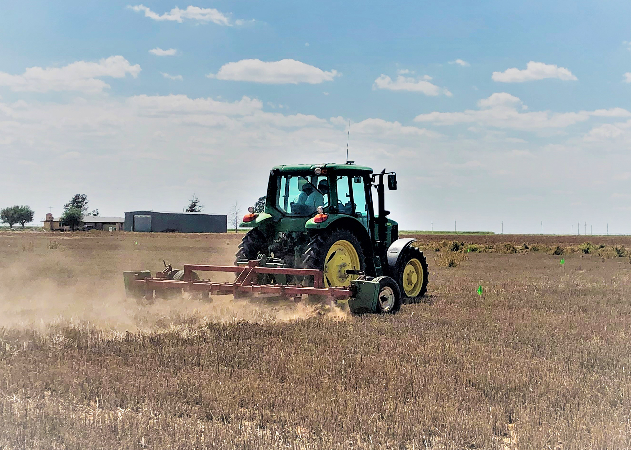 A tractor tills a field