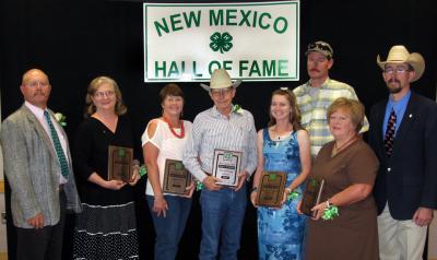 Group of people in front of the New Mexico 4-H Hall of Fame sign.