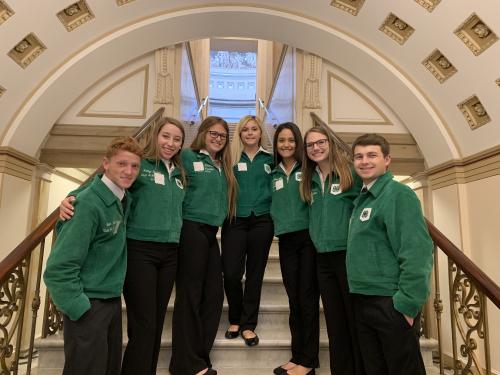 Group of students pose on stairs