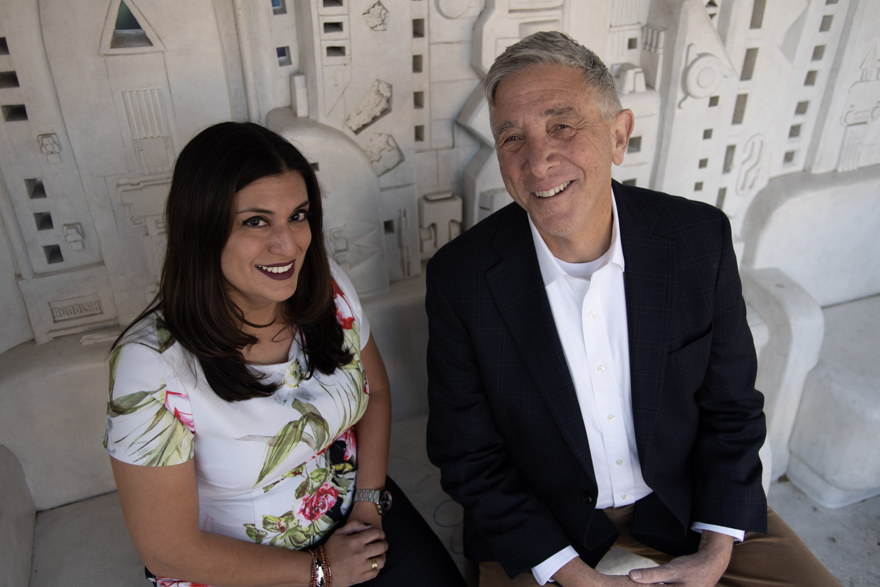 Woman on the left and man on the right are seated.
