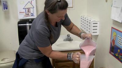 Woman pouring pink liquid