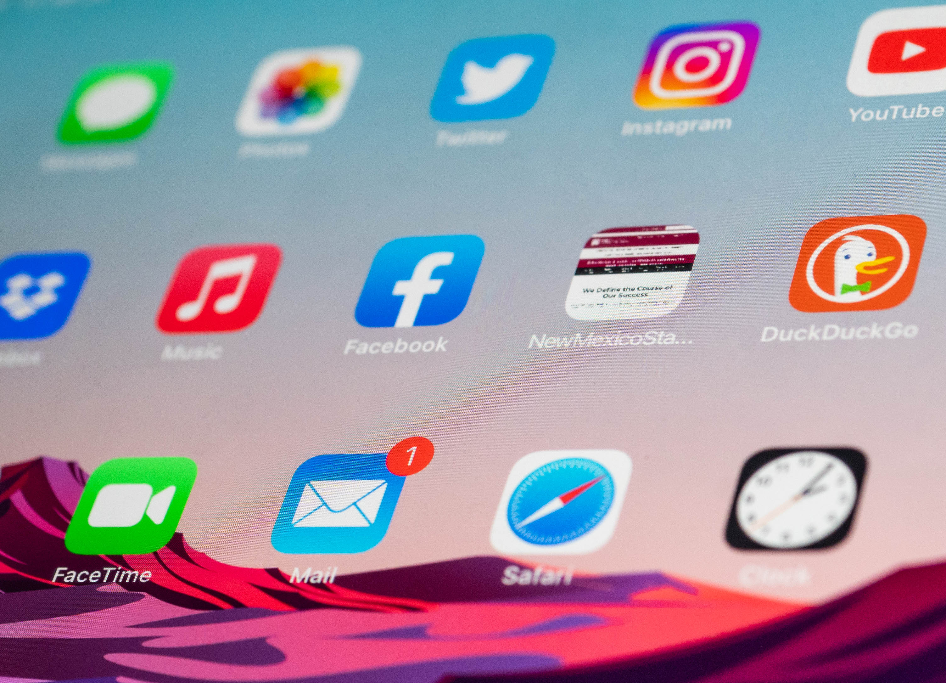 Closeup of a phone screen with social media app icons.