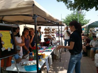 Students sell craft items at the downtown farmers market.