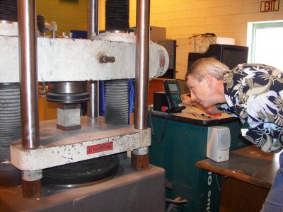 Man examining concrete in lab