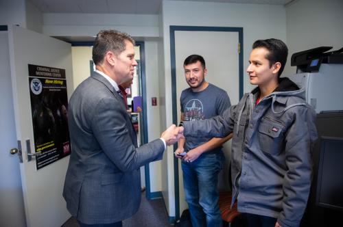 man and student shaking hands