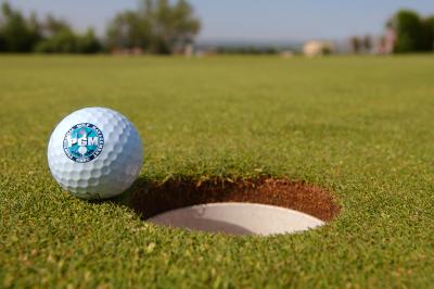 Close up of golf ball with NMSU PGA Golf Management logo