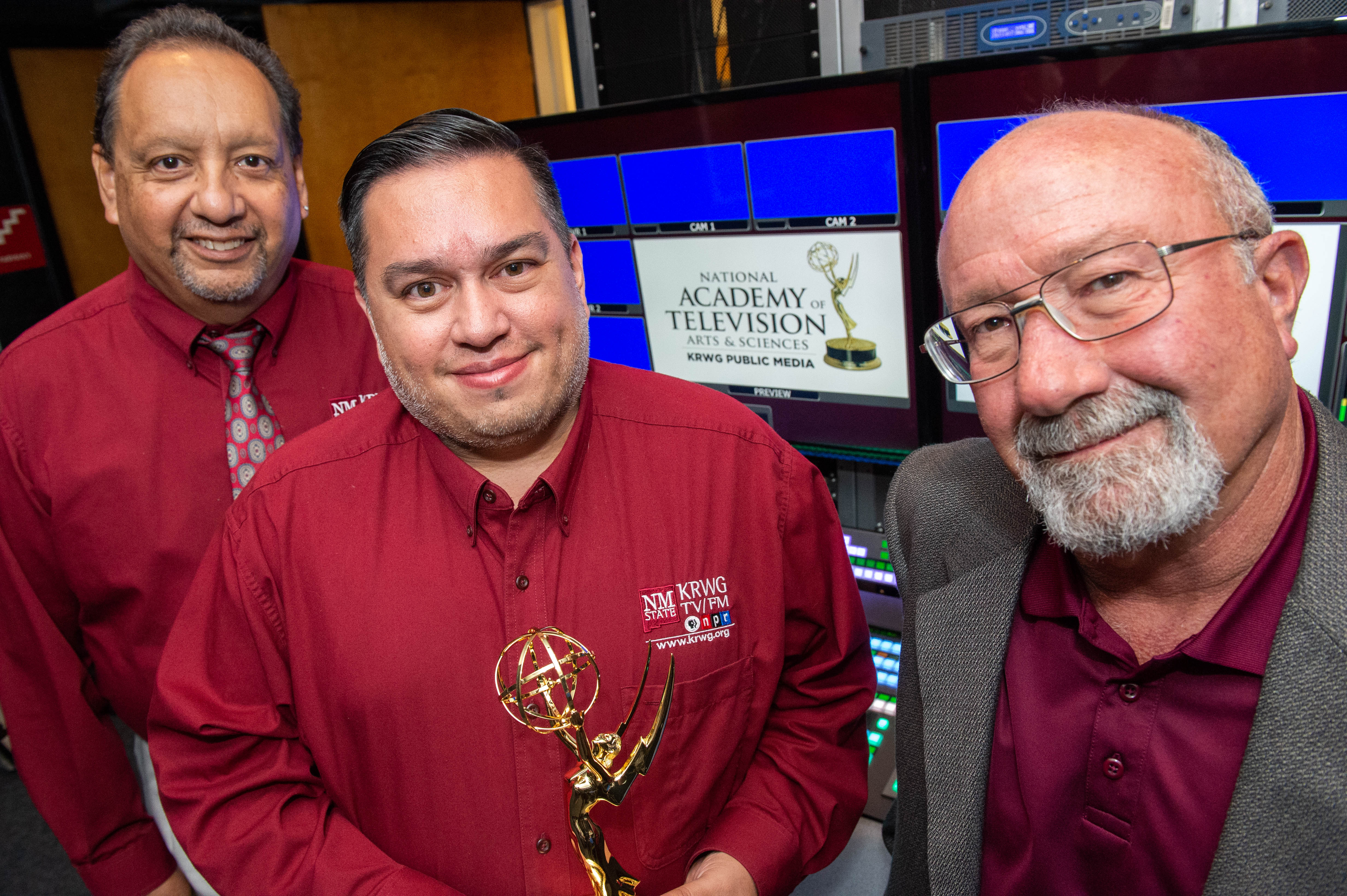 Photo of three men with award