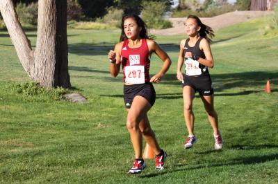 NMSU cross-country runner Lizbeth Mata running, with a another runner behind her.