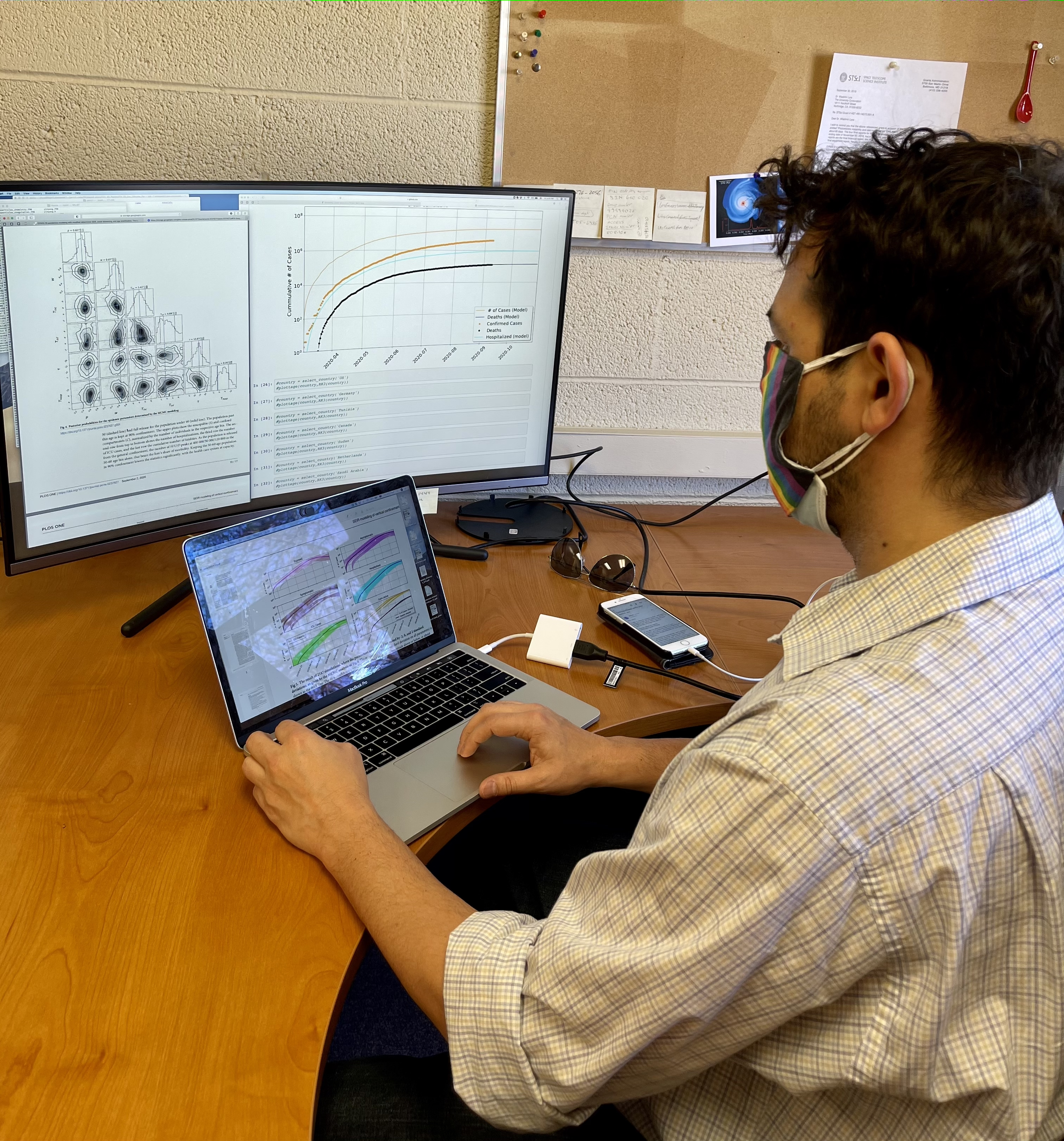 man on computer with graphics