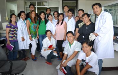 Michele Nishiguchi standing among a group of students