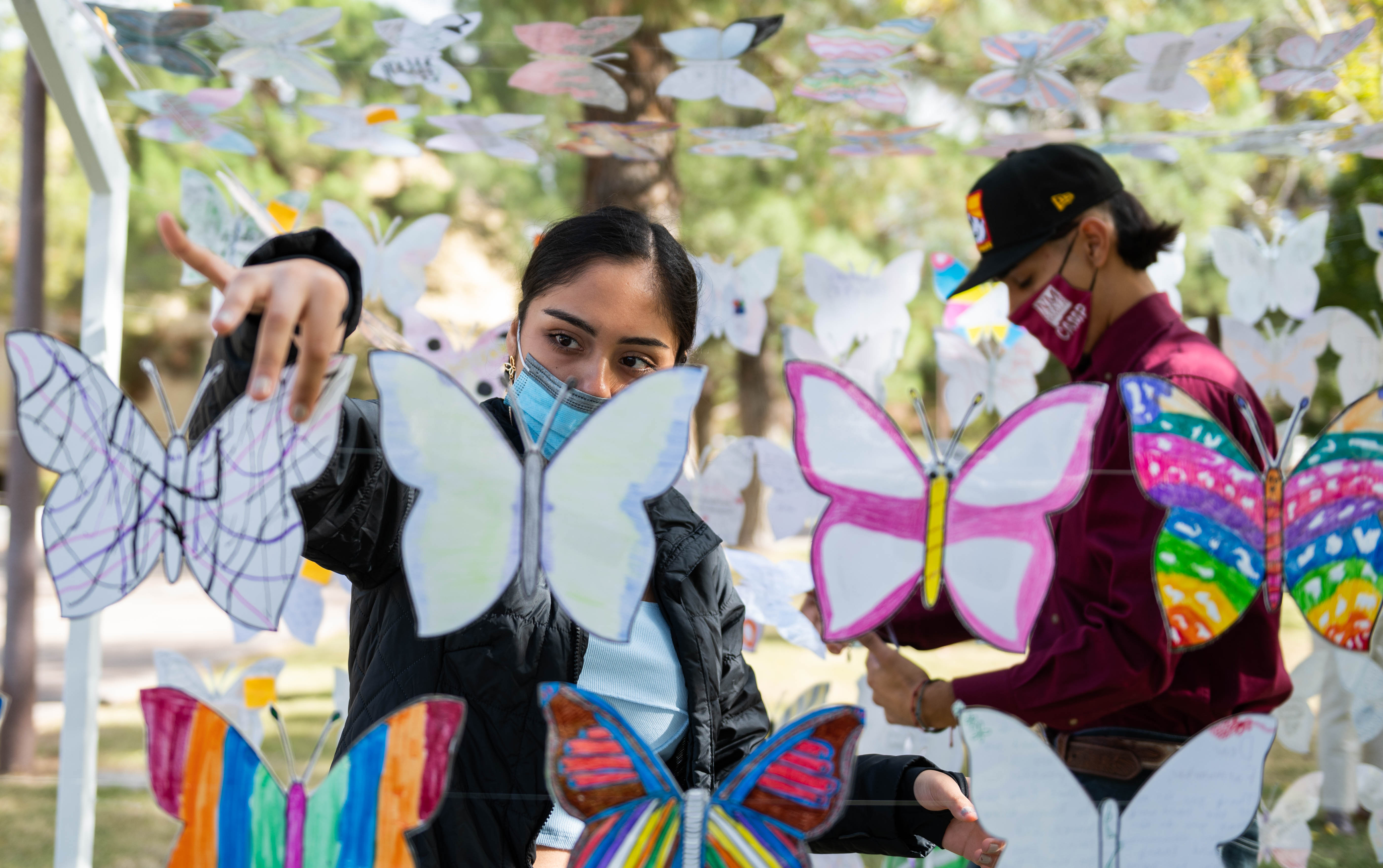 woman straightening butterflies wings