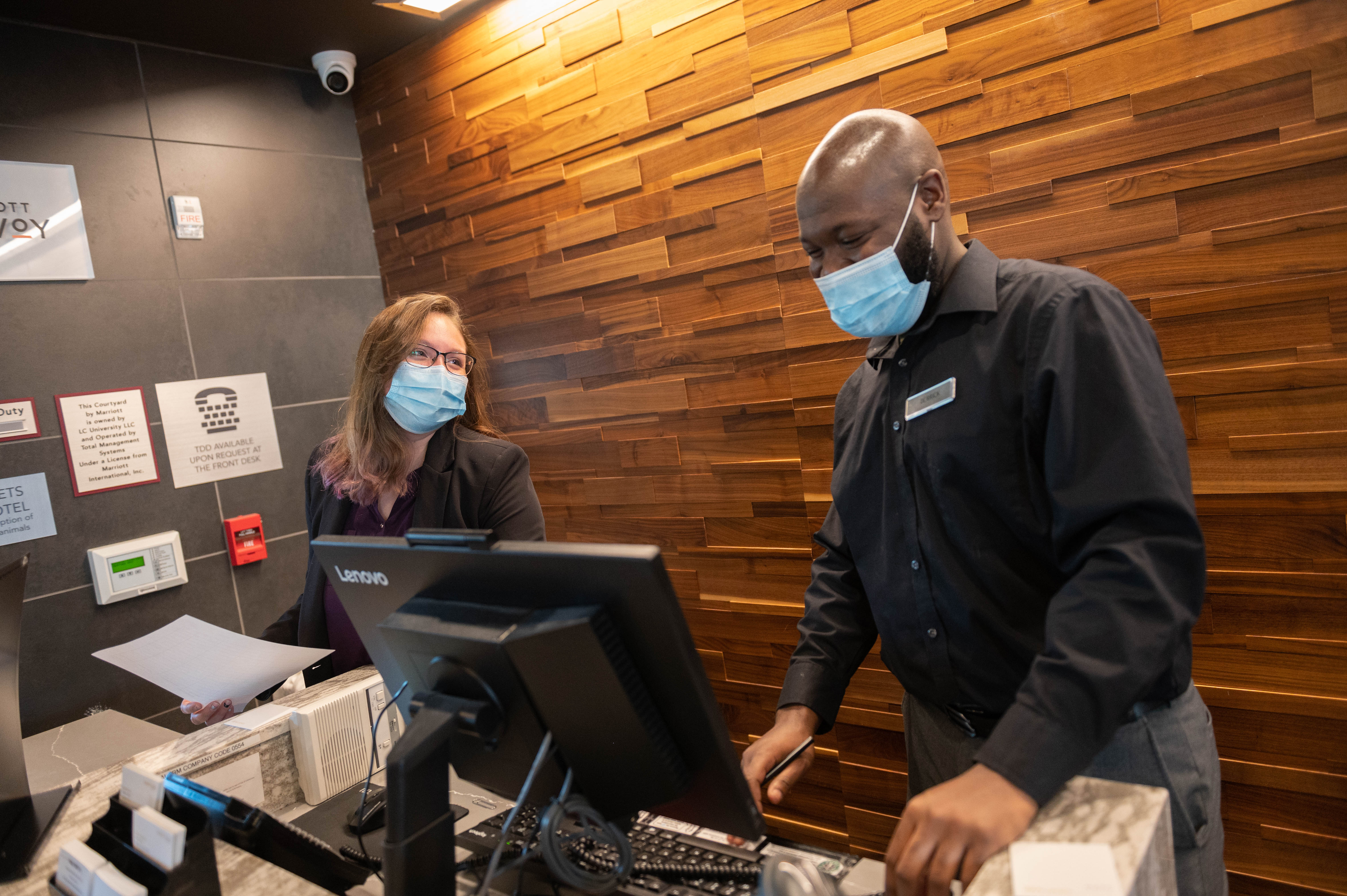 Hotel employees work at desk