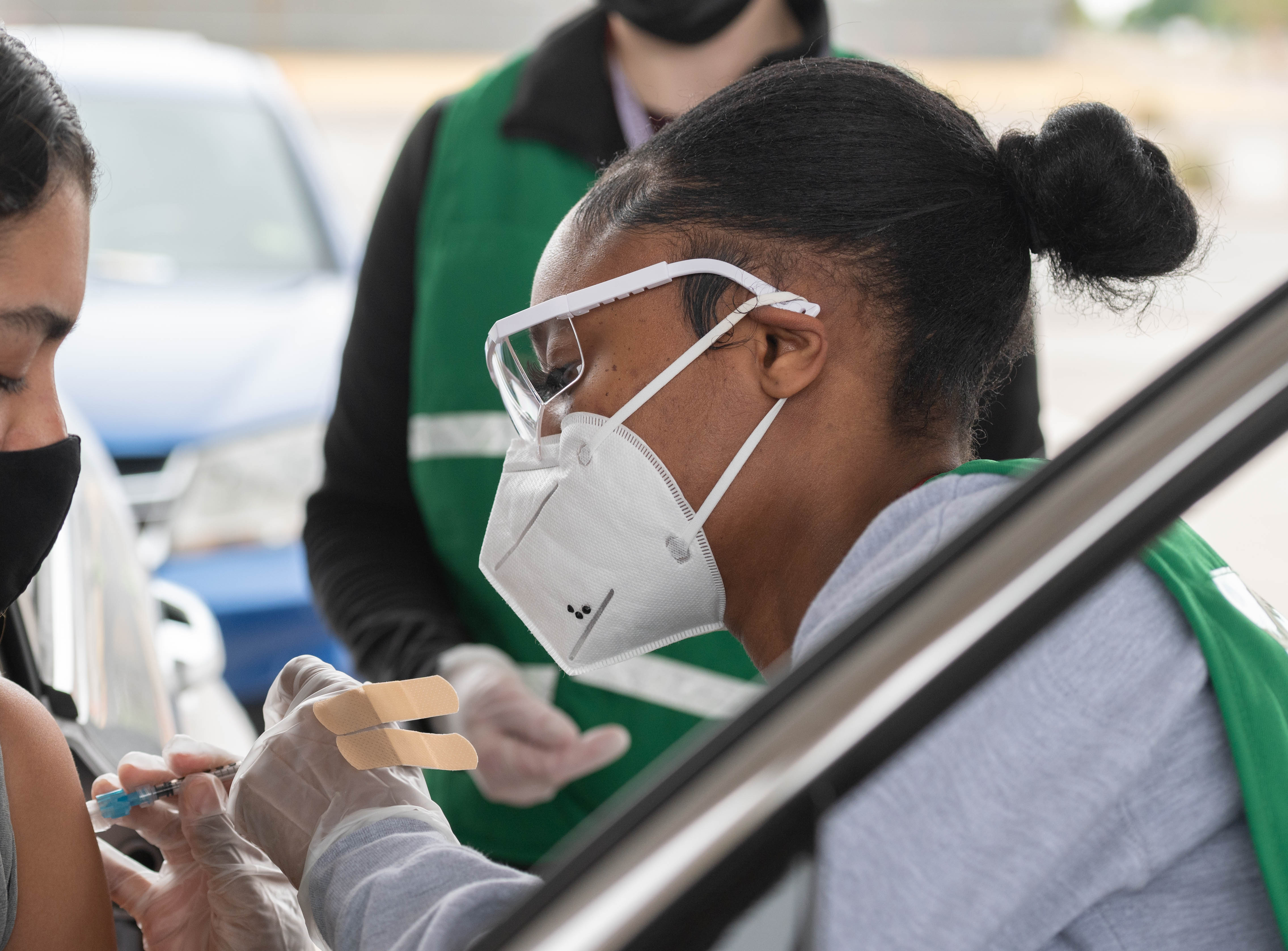 A student gives a shot