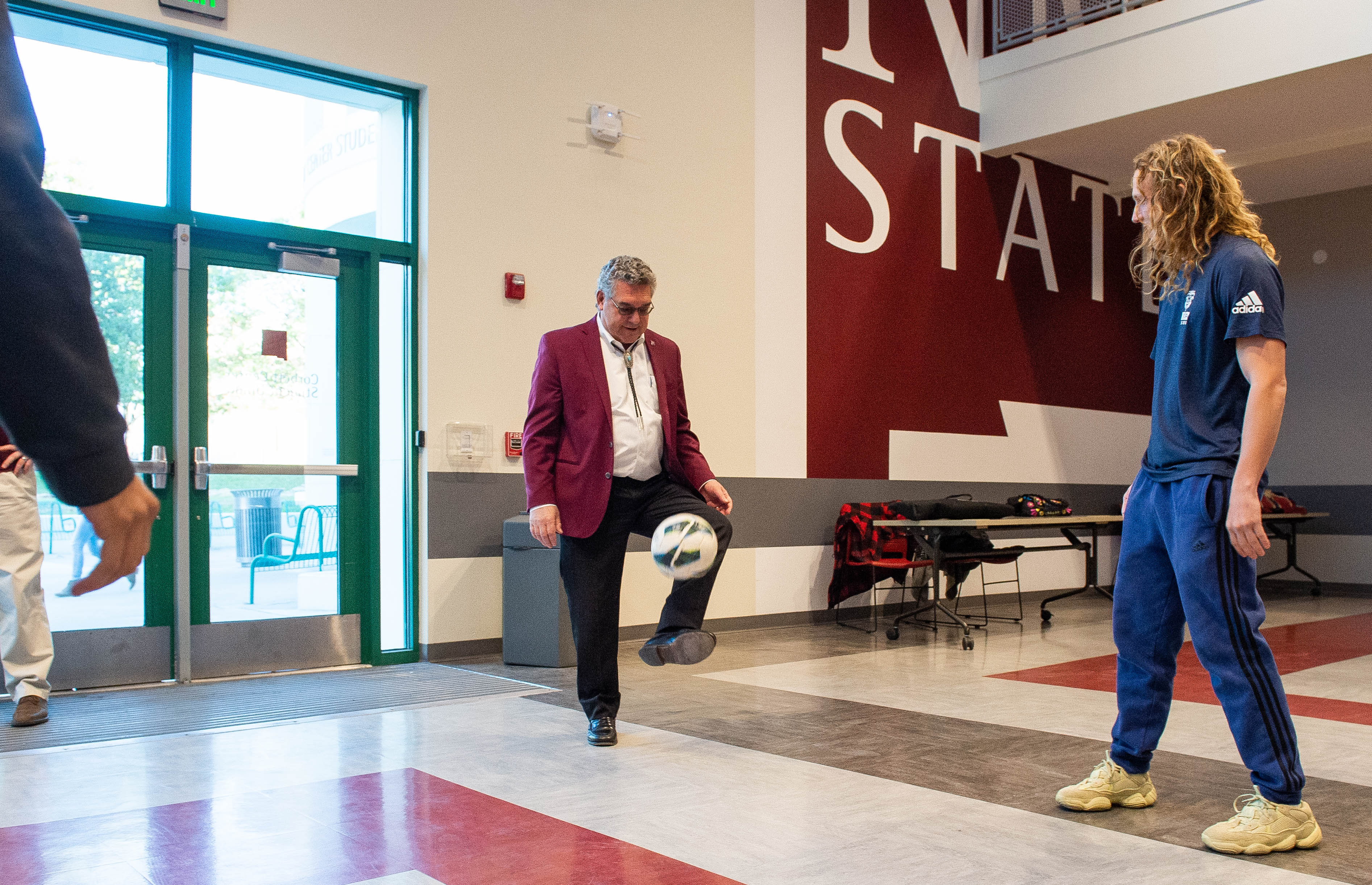 NMSU President John Floros juggles a soccer ball