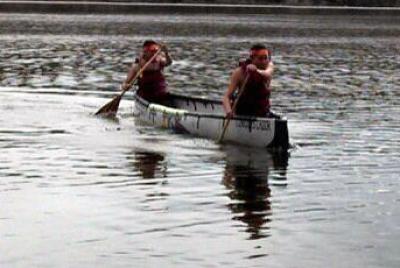 Two NMSU students paddle the Conquistador during the Concrete Canoe competition