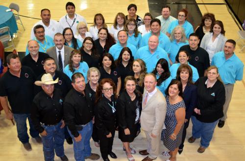 Large group of people in black, white and turquoise shirts