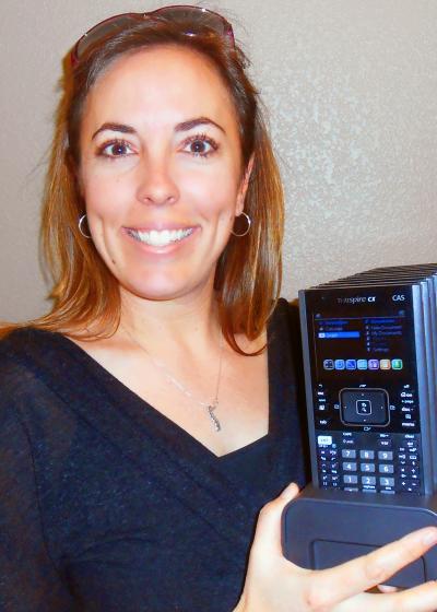 Arrowhead Park Early College High School Teacher Nina Nunez holds a container of TI-Nspire calculators.