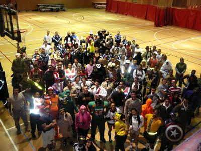 A large group of people wearing Halloween costumes