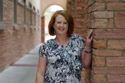 Woman next to brick wall