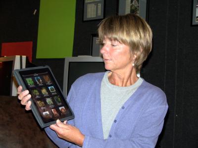 Women  holding an iPad with colorful squares on it.