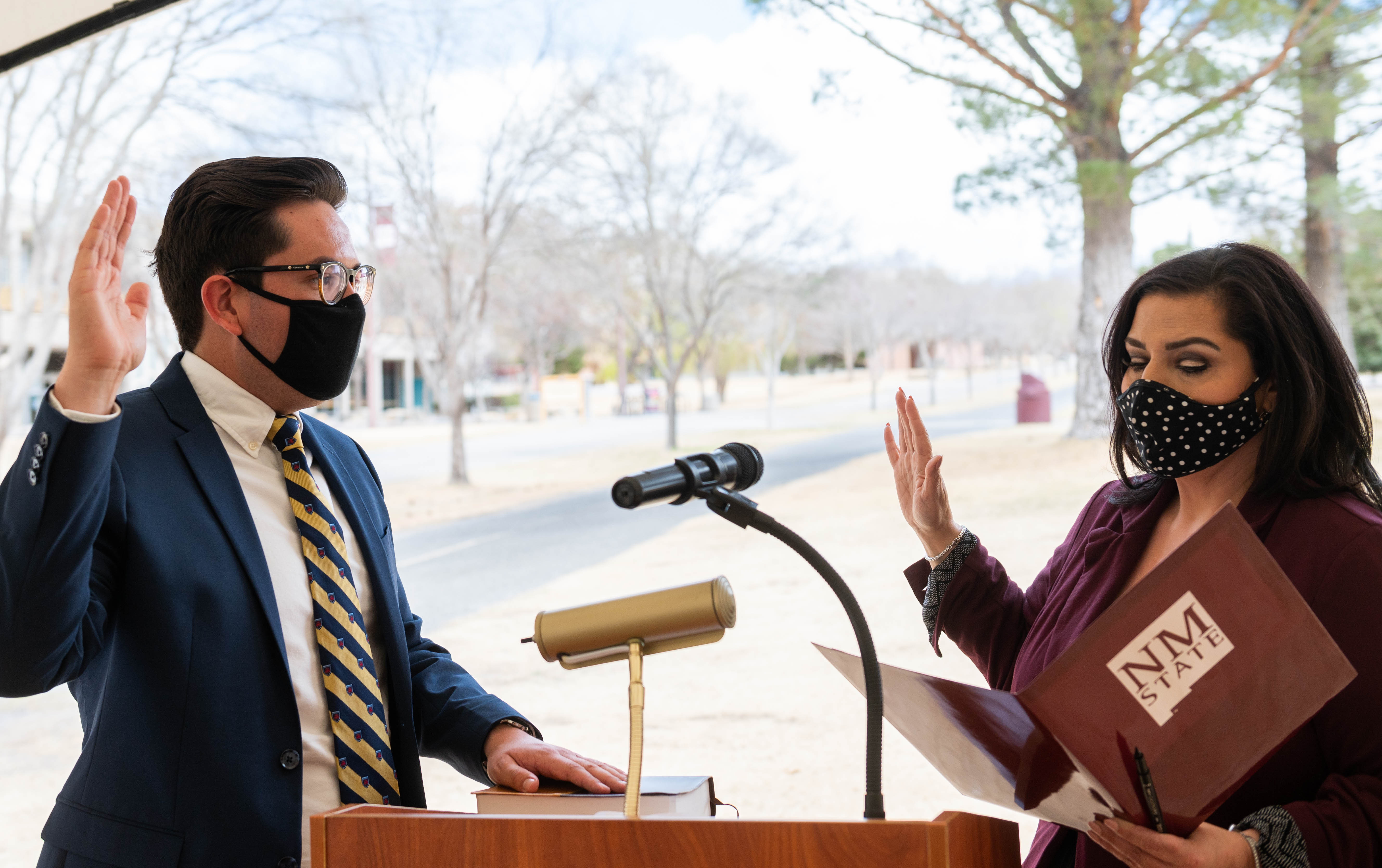 Man and woman stand by podium