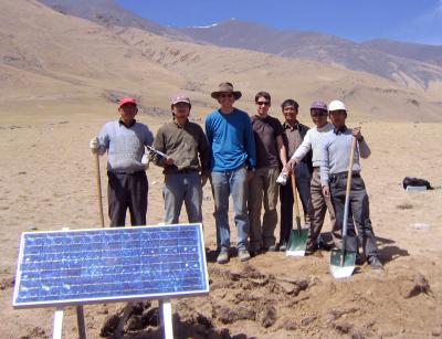 A group of researchers stand together on a plateau