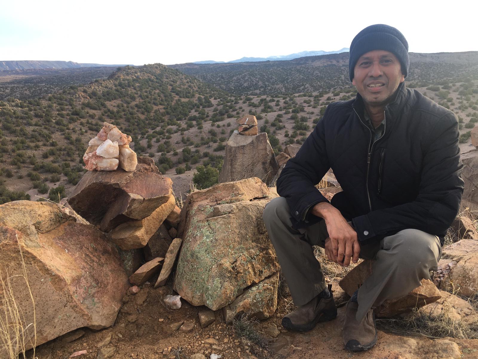 Man sitting on rocks and smiling