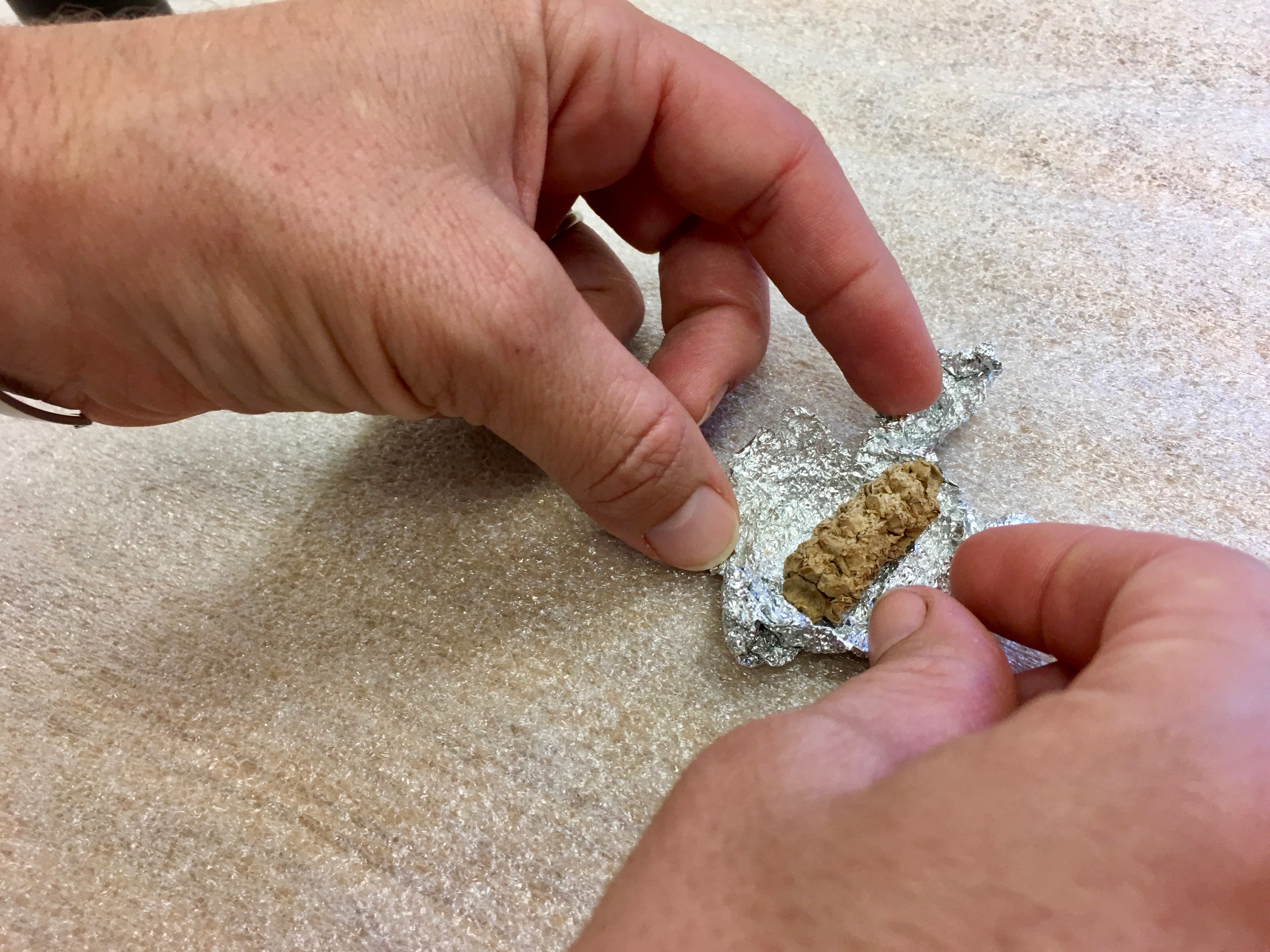 person looking at corn cob 