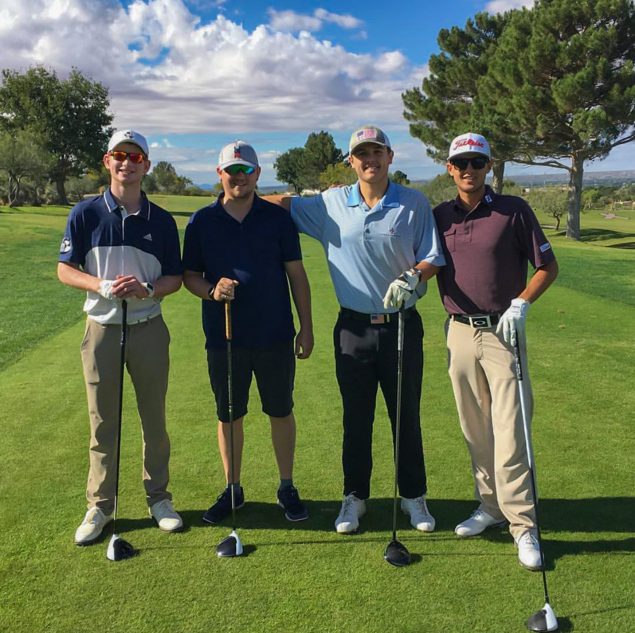 Four golfers on a golf course