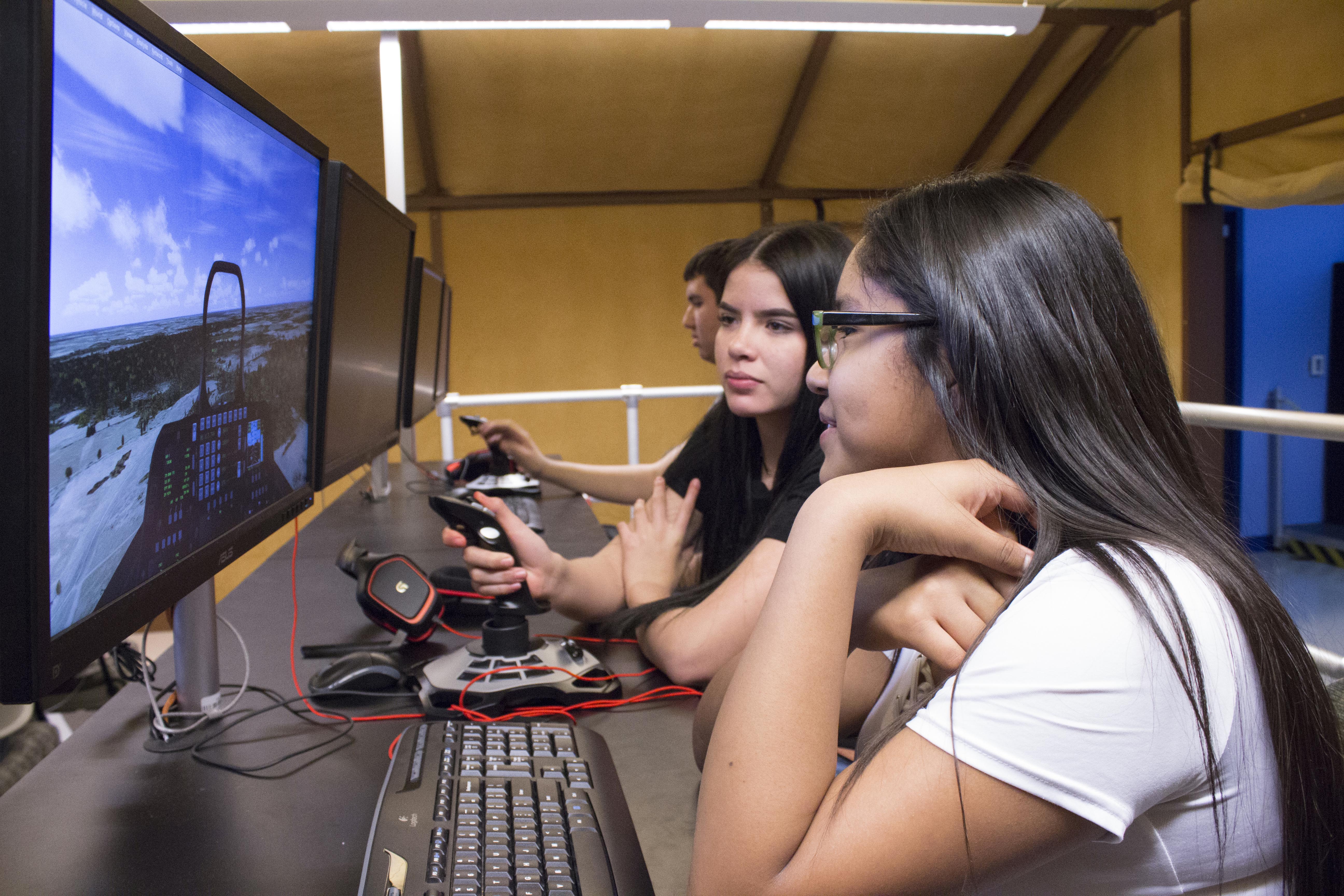 Two female students looking at computer screen.