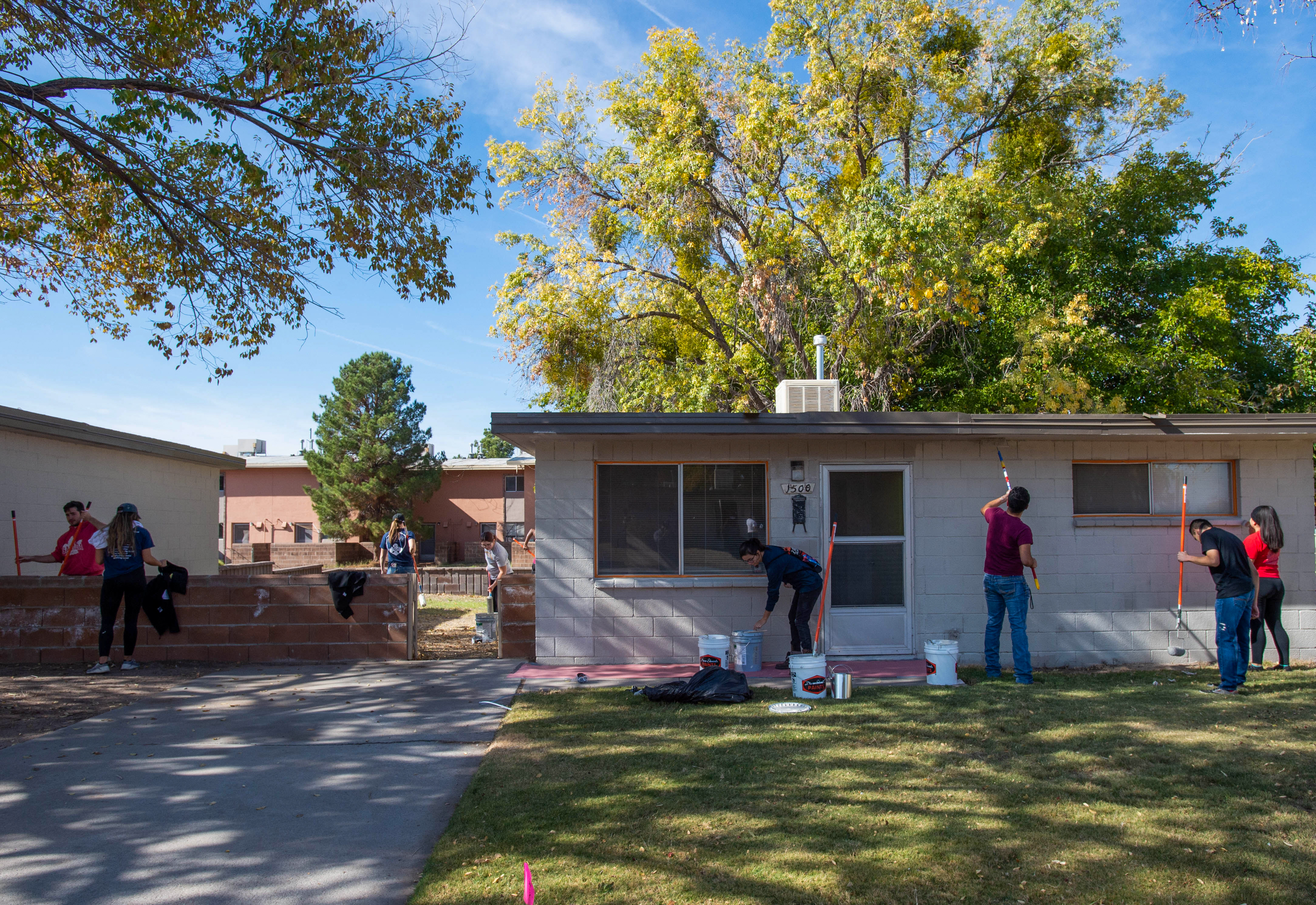 People painting the exterior of a house. 